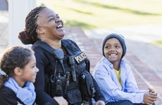 Policewoman in the community, sitting with two children