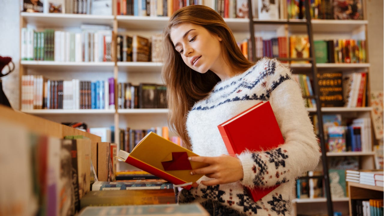 Woman looks through books at a bookstore