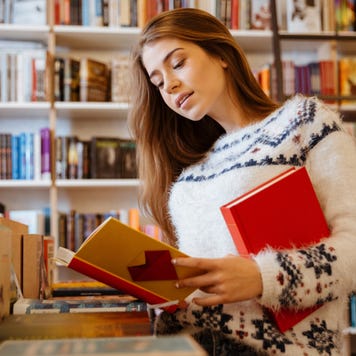 Woman looks through books at a bookstore