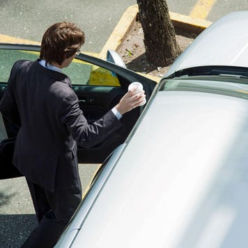 man getting into his car