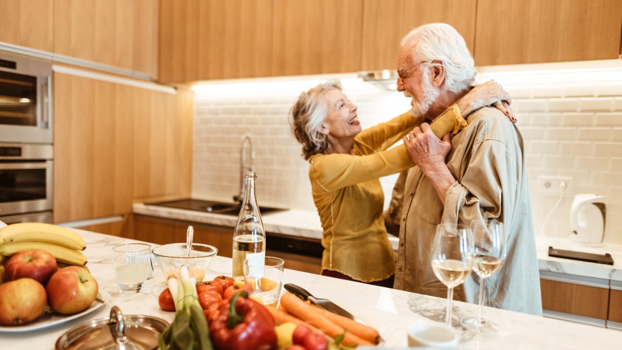 senior couple dancing in the kitchen