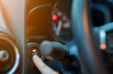 closeup hand pushing on car start engine, Woman driver pushing a start ignition button switch in the modern luxury car