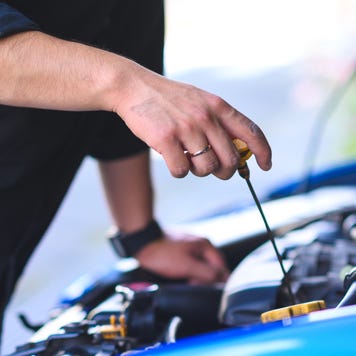 Cropped Hands Of Mechanic maintain car, engine oil check and replace