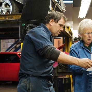 A mechanic discusses a bill with a customer