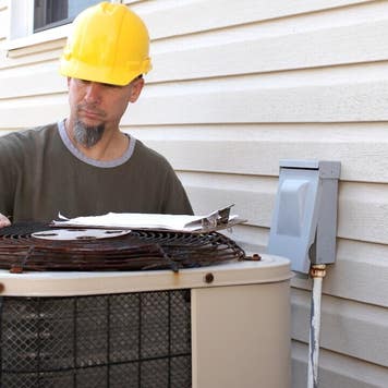 A A/C technician tests a new install