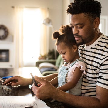 Man with baby at computer.