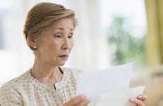 USA, New Jersey, Jersey City, Senior woman reading letter