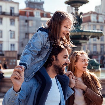 Family smiling outside
