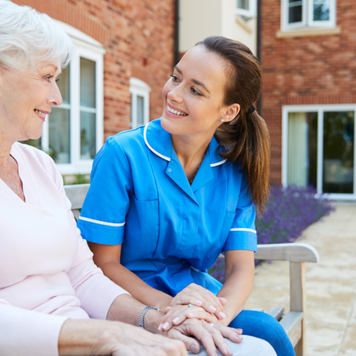 Nurse talks with a woman in a retirement home
