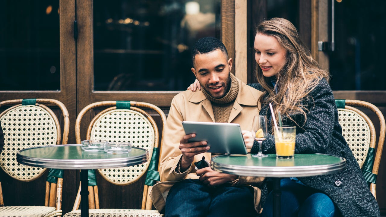 Couple at outdoor cafe.