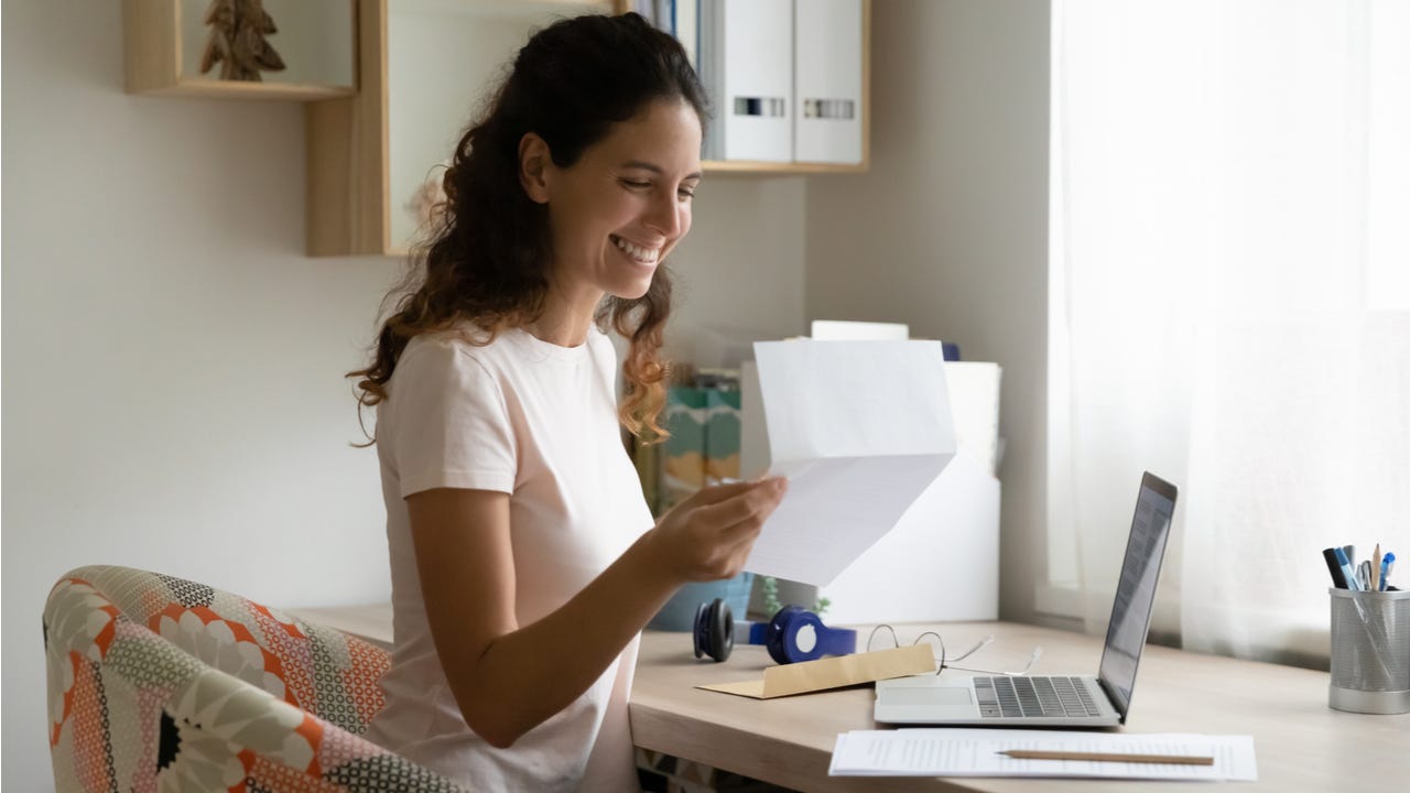 Woman celebrates after receiving a letter