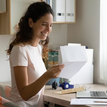 Woman celebrates after receiving a letter