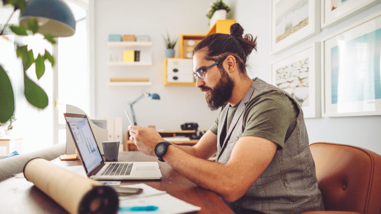 Young adult looking at charts on laptop