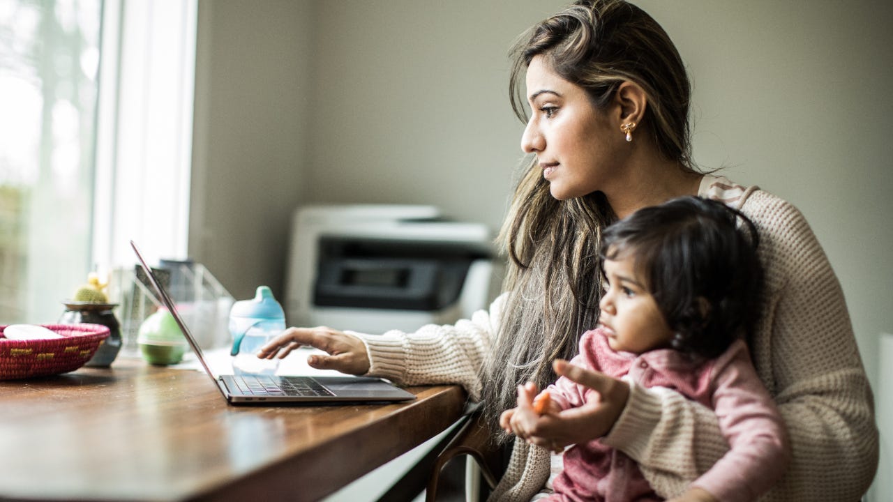 Mother working from home with infant