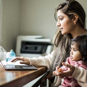 Mother working from home with infant
