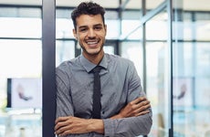 Young man in an office smiling for the camera