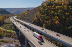 Scenic aerial view of the high bridge at the Pennsylvania Turnpike lying between mountains in Appalachian on a sunny day in fall.
