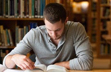 Man studies in a college library