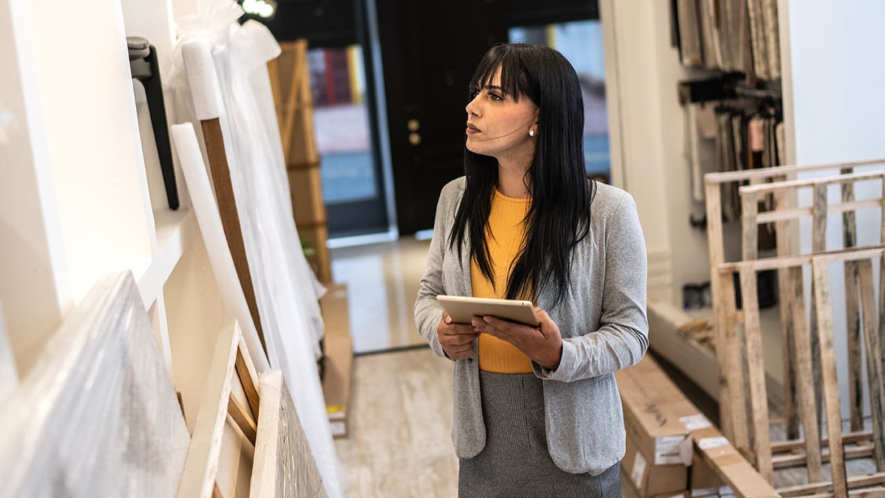 Transgender woman using the digital tablet at architects' studios