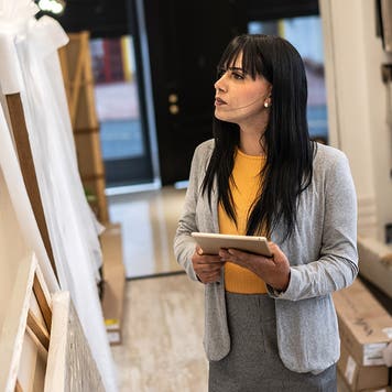 Transgender woman using the digital tablet at architects' studios