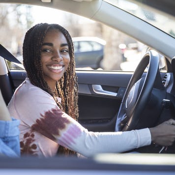Mother handing car keys to teenage daughter