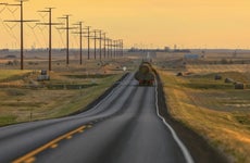 Truck carrying hay bales on rural highway