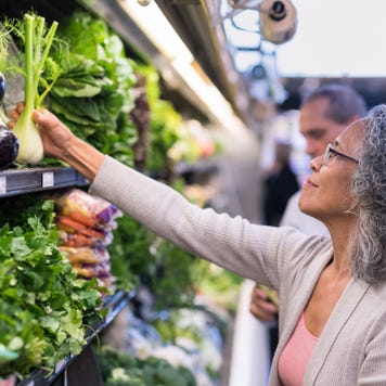 Woman at grocery store in produce section