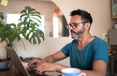 Man on laptop with mug