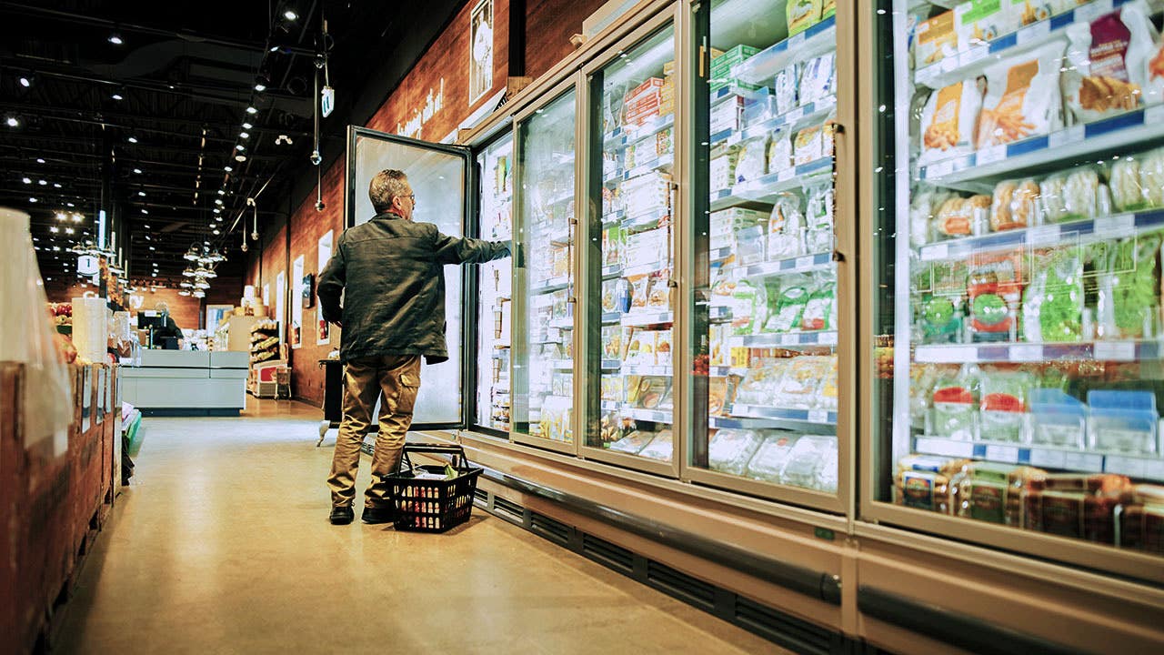 Shot of a mature man shopping in the cold produce section of a supermarket