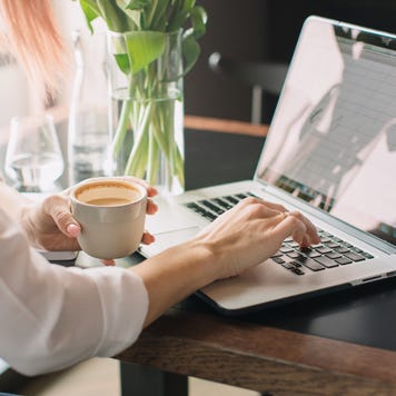 A woman works on her laptop