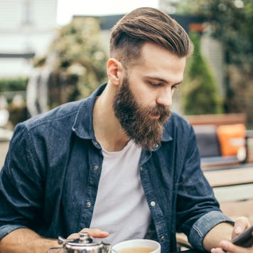Millennial man looking at smartphone