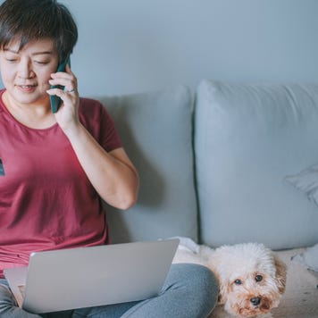 Woman with dog and credit card and laptop