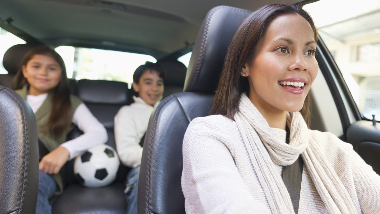 USA, New Jersey, Jersey City, Mother with son (12-13) and daughter (10-11) in car