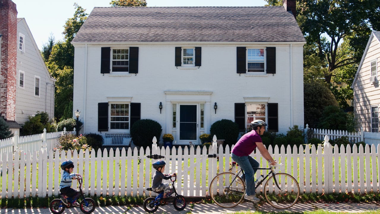 Family biking outside of suburban home