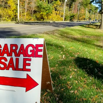 Garage sale in grass on street curb with autumn trees background
