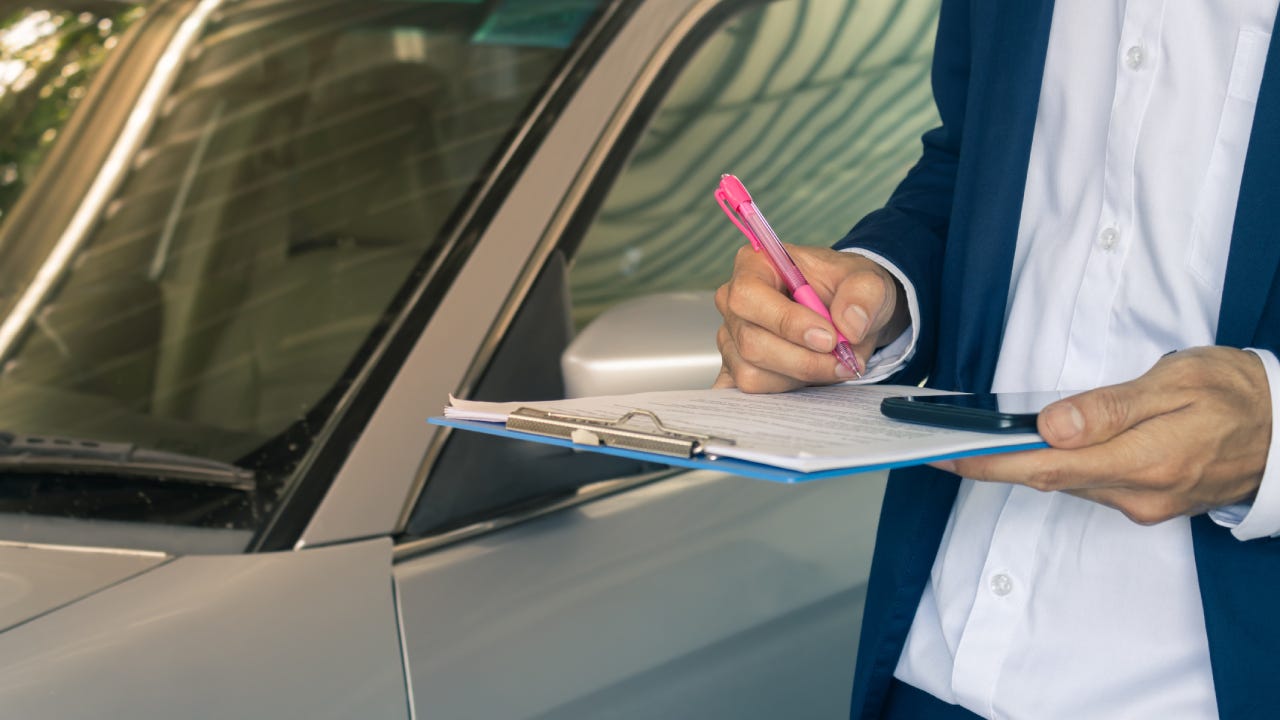 Standing Asian Insurance Agent or Insurance Agency Checking Car Crash Data Report in Vintage Tone