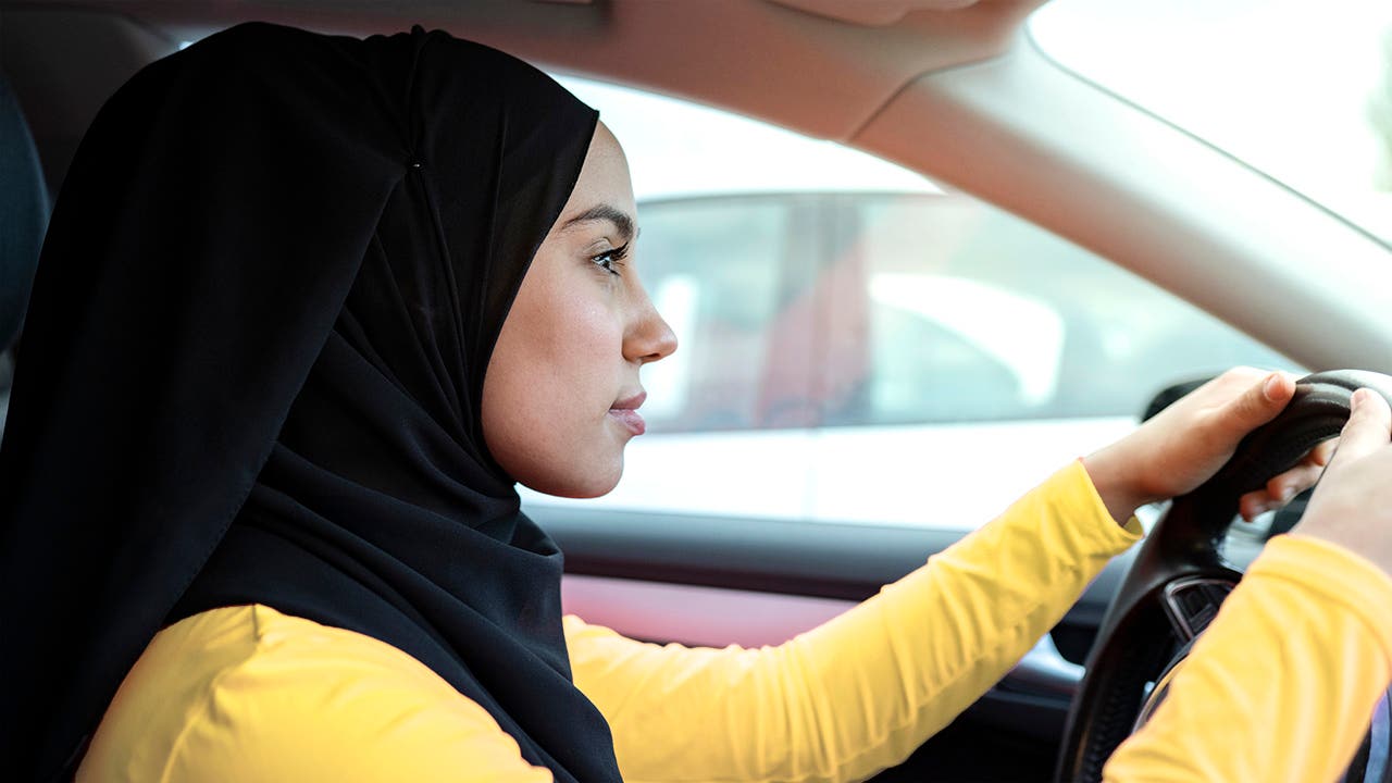 A person in a hijab driving a car.