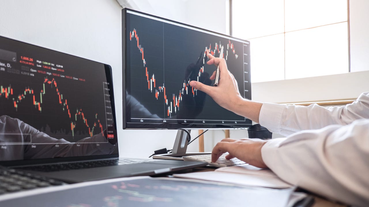 Cropped Hands Of Businesswoman Analyzing Stock Market Data Over Computer In Office