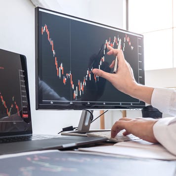 Cropped Hands Of Businesswoman Analyzing Stock Market Data Over Computer In Office