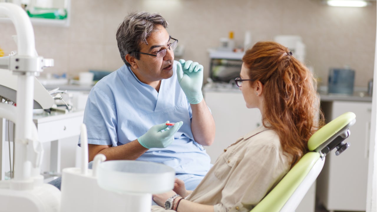 Dentist explains treatment to a patient