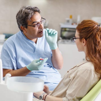 Dentist explains treatment to a patient