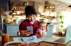 Young mother with baby and smartphone