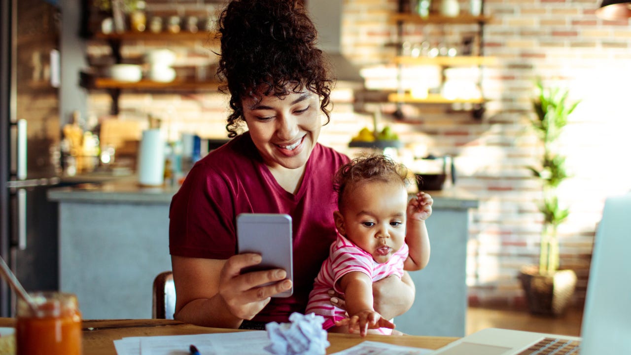 Young mother with baby and smartphone