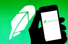 An image of the Robinhood logo and the app on a phone