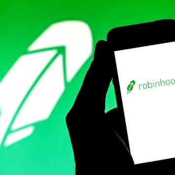 An image of the Robinhood logo and the app on a phone