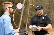 A police officer writing a driver a speeding ticket.