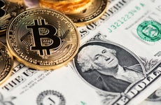 Bitcoin and one-dollar bill side by side