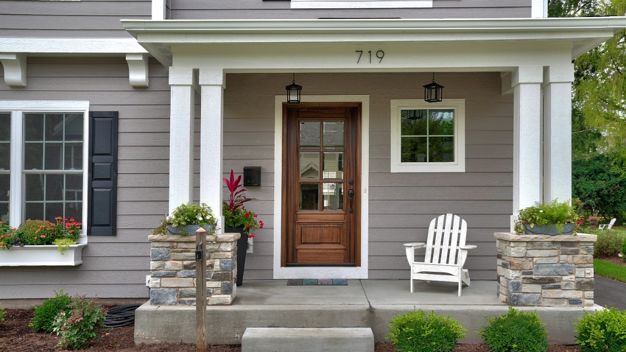 Front porch and entrance to a newly built home. The address, 719, is above the door in a modern font.