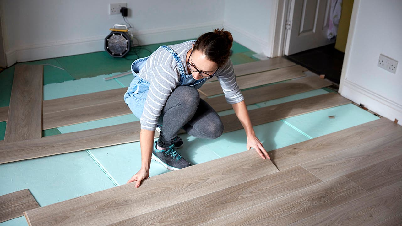 woman installing new floors