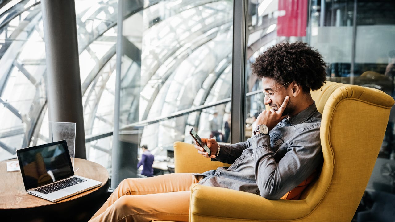 Young man in chair on smartphone